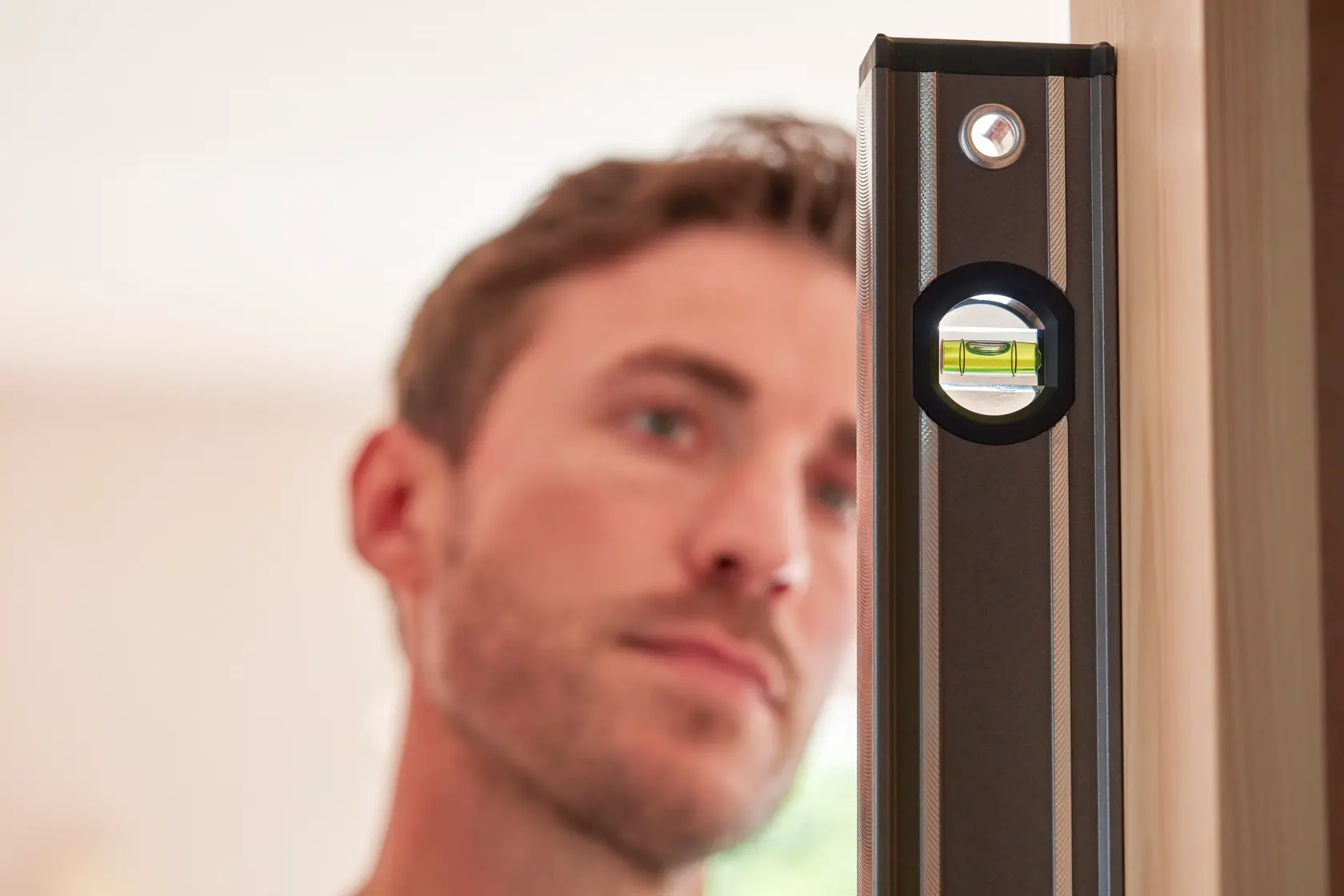 STANLEY 0-43-648 spirit level close-up in use, highlighting bubble vial, indoor setting.