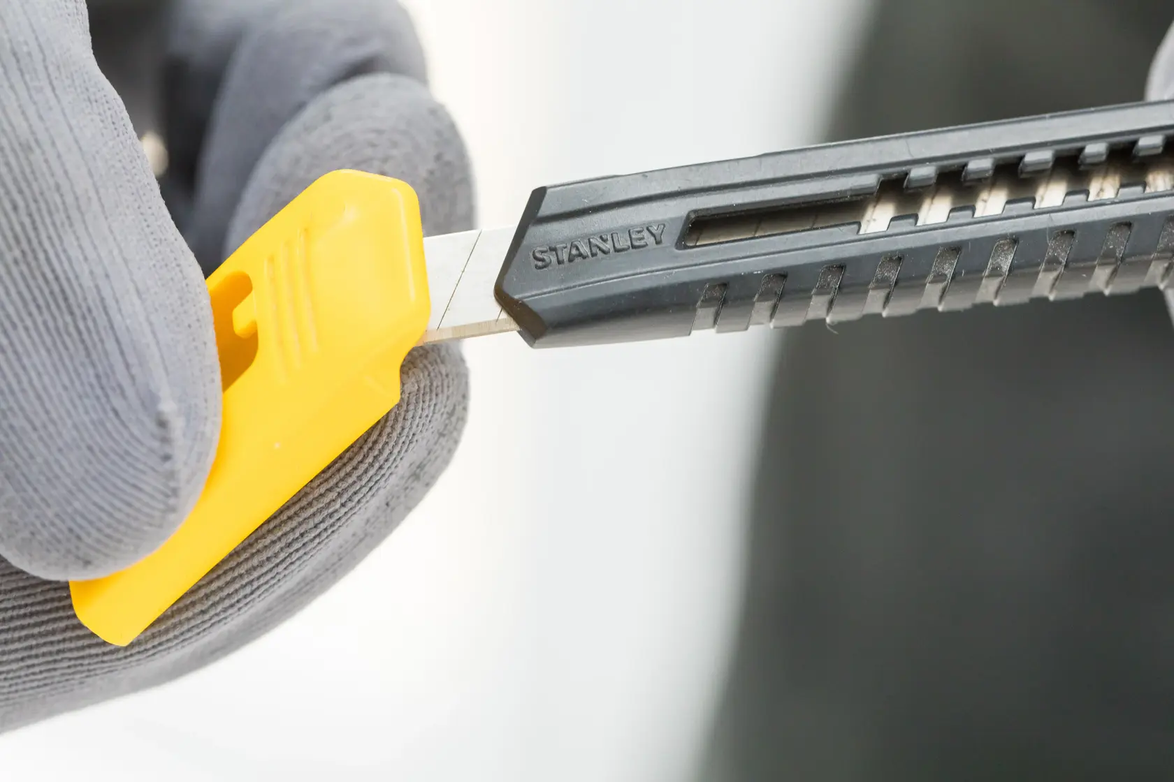 Stanley utility knife with a retractable blade, black and yellow handle, shown on white background.