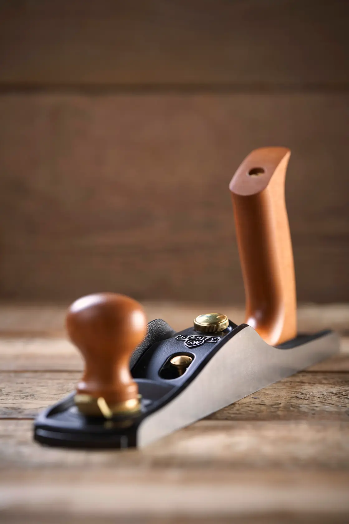 STANLEY 1-12-137 hand plane with wood handles, angled view on rustic wood surface.
