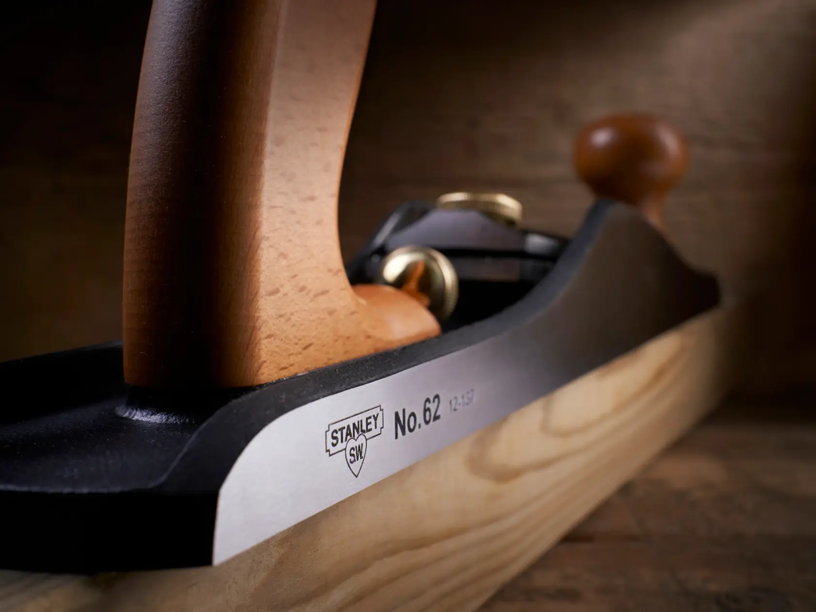 Close-up photo of STANLEY 1-12-137 hand plane with wooden handles on a wood surface.