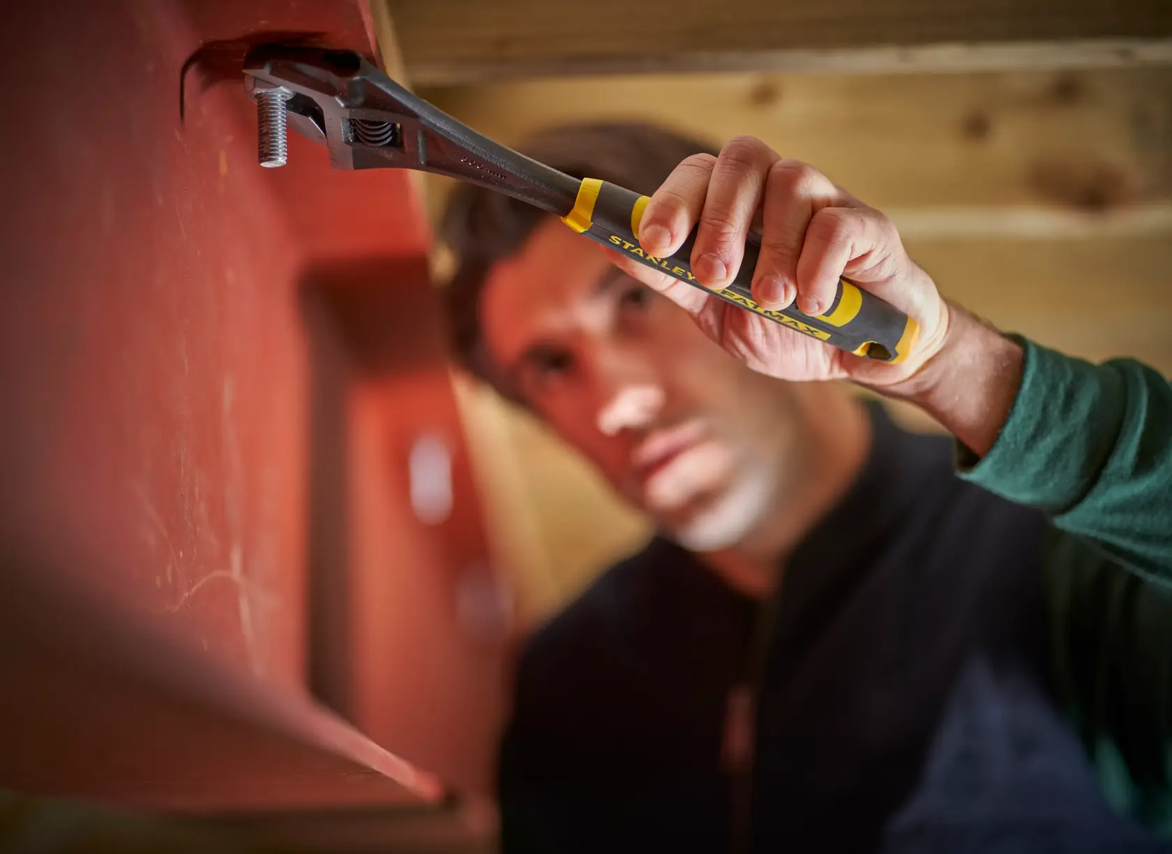 Photo of STANLEY FMHT13125-0 adjustable wrench turning a bolt on a red metal beam.