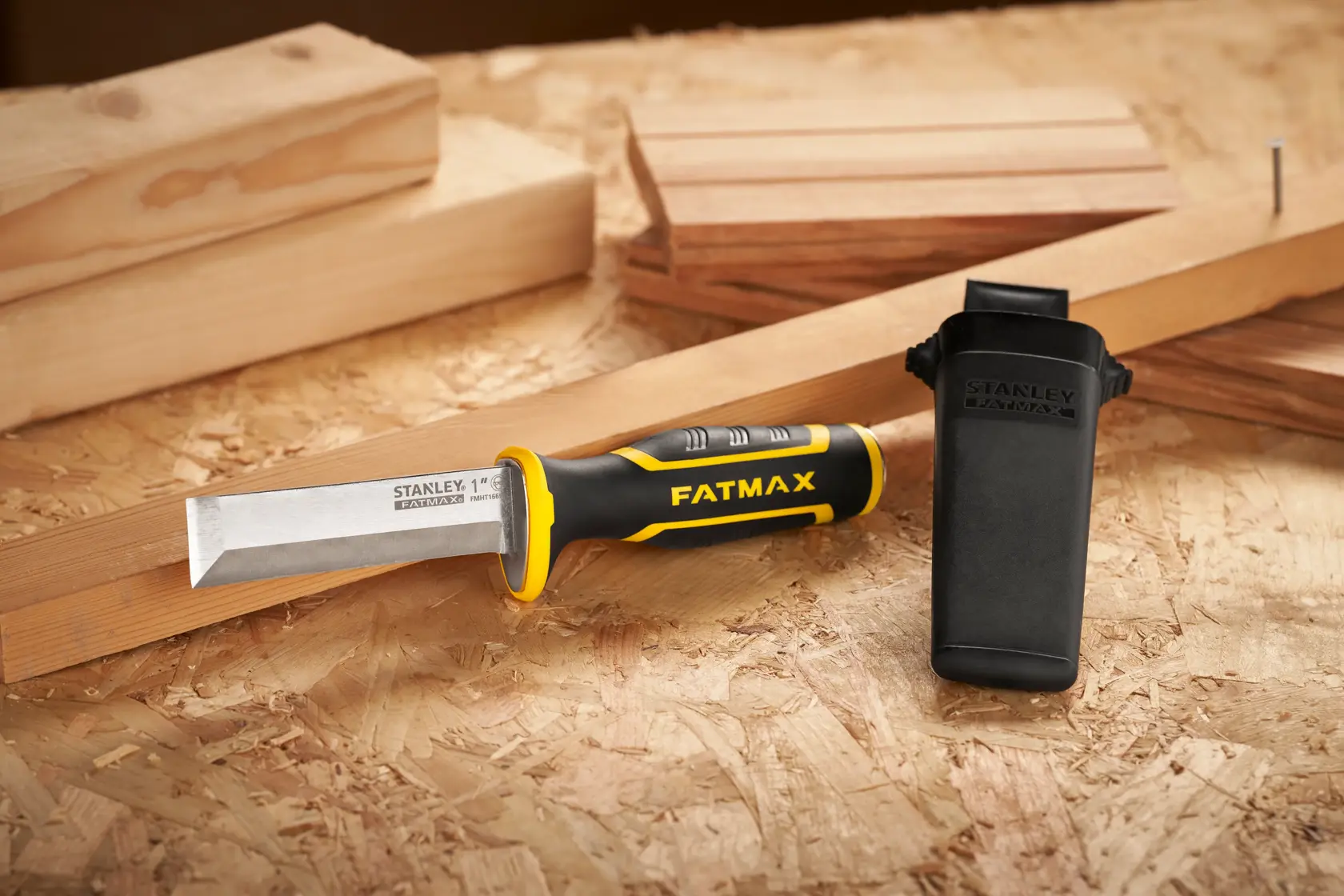 STANLEY FMHT16693-0 chisel with black and yellow handle and protective cover on wood surface.