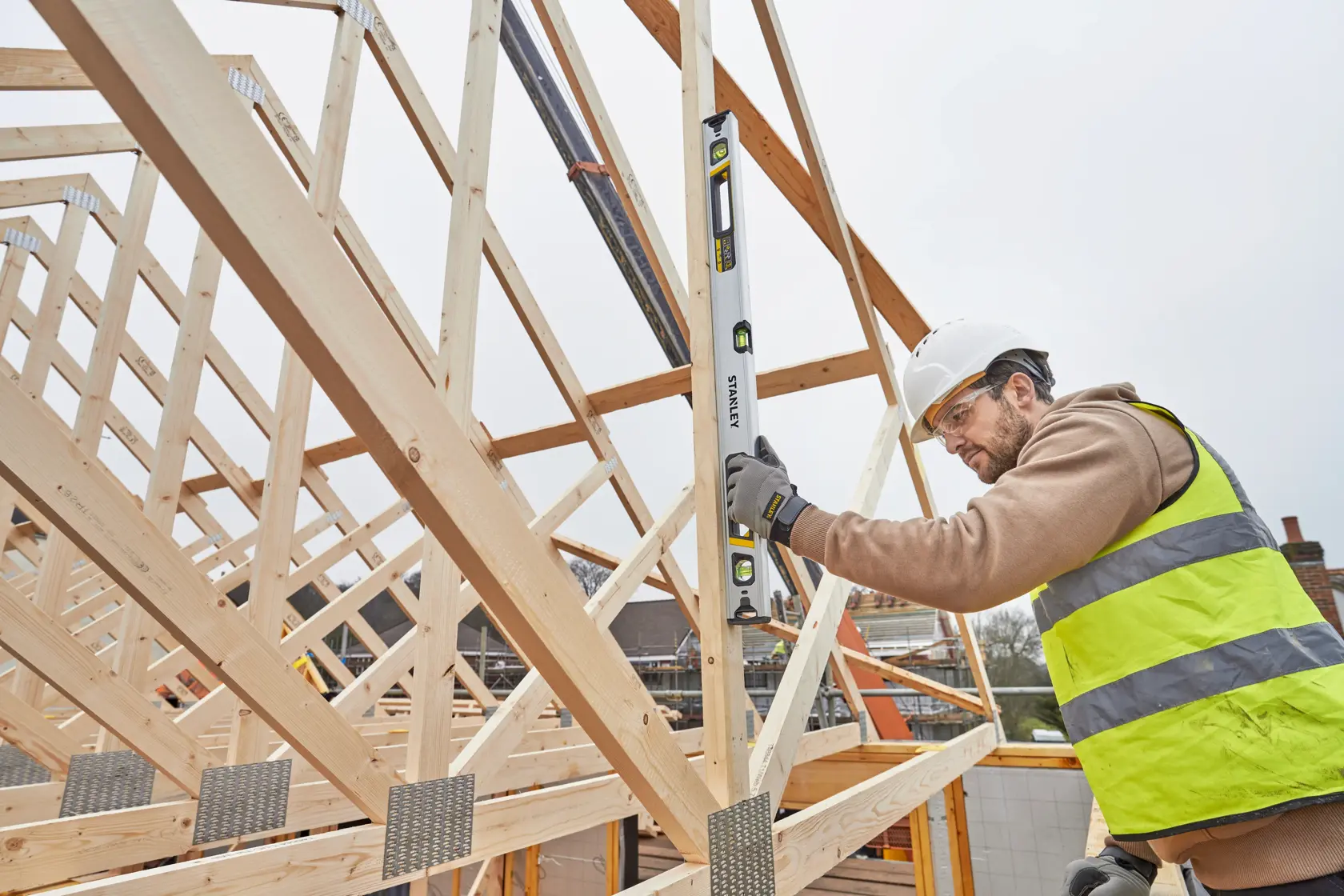 STANLEY FMHT43675-1 spirit level in use on timber frame construction site.
