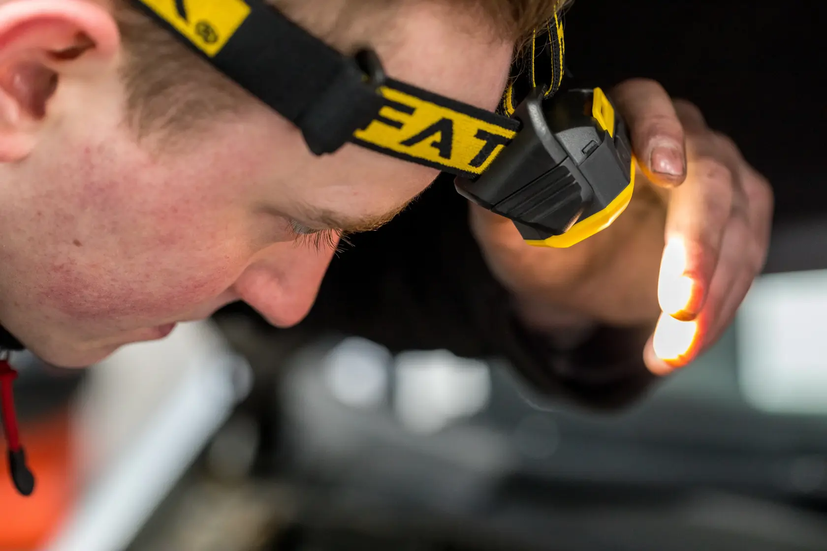 STANLEY FMHT81509-0 headlamp, yellow and black, worn during inspection, product detail photography.
