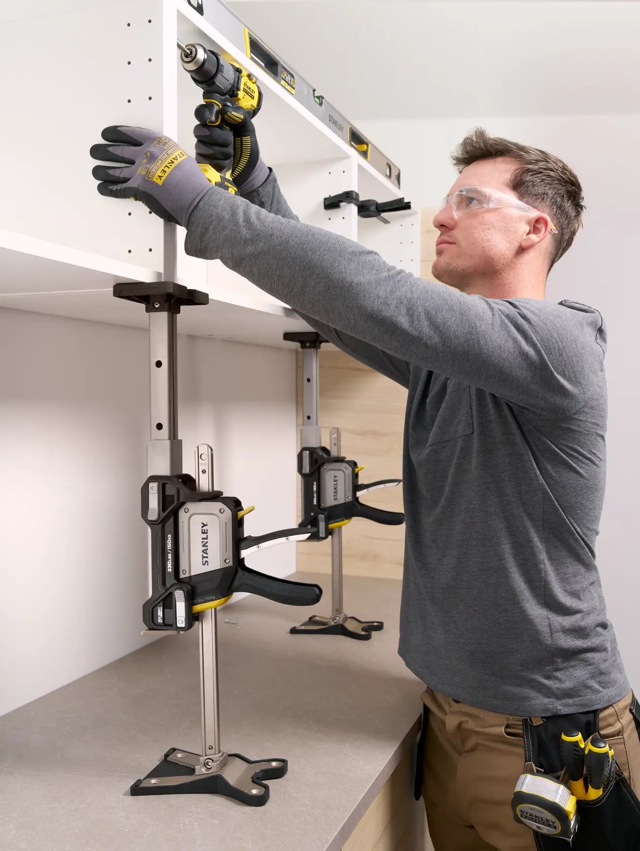 Photo of STANLEY FMHT83554-1 support clamp used to hold a cabinet in place during installation, shown from a side angle.