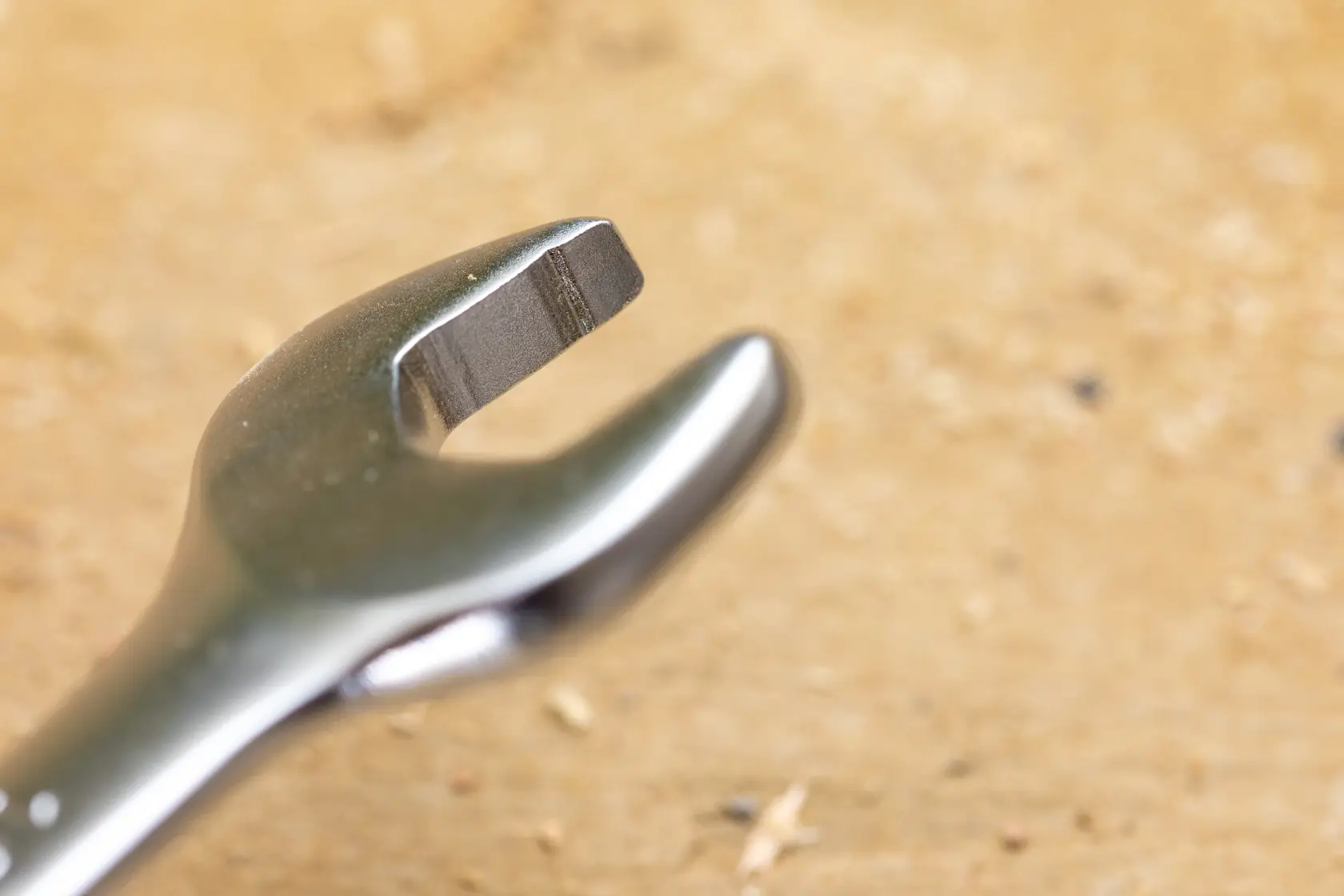 STANLEY FMMT13094-0 open-end wrench close-up, silver metal tool on wood surface, photography