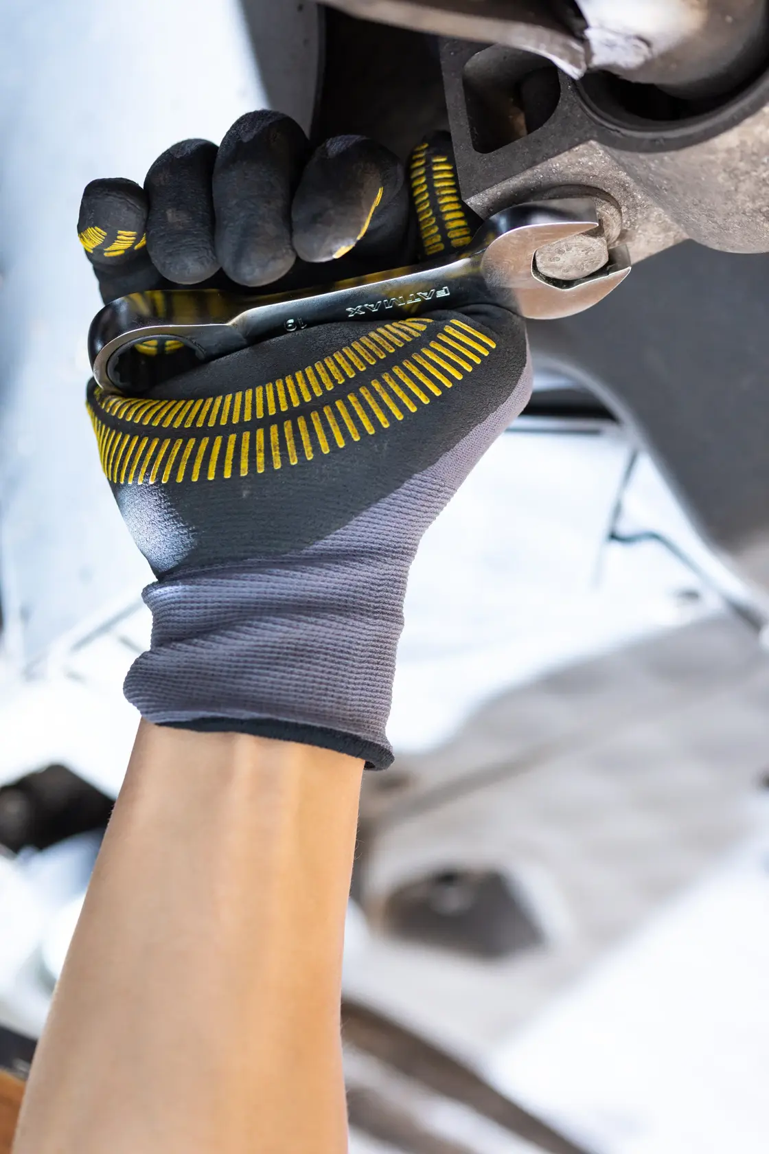 Photo of STANLEY FMMT13109-0 wrench tightening a bolt, gloved hand, close-up angle, tool category.
