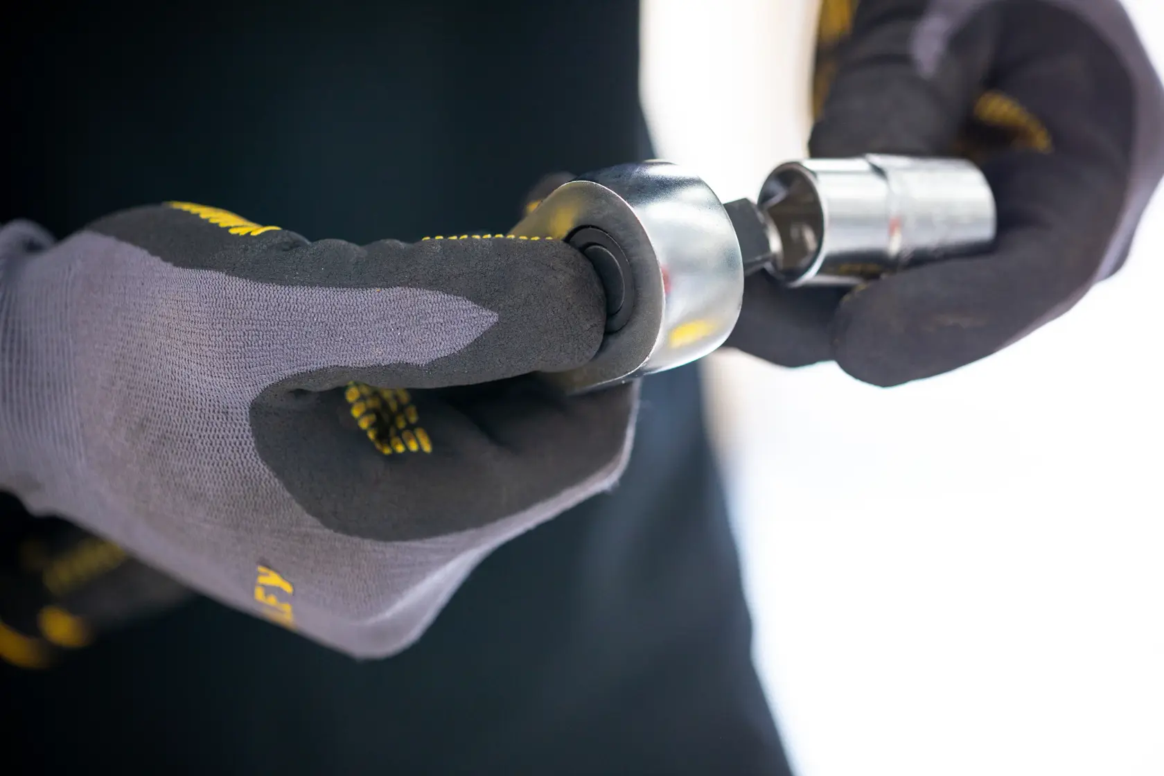 Photo of STANLEY FMMT17227-0 socket tool held by gloved hands, close-up view, photography category.