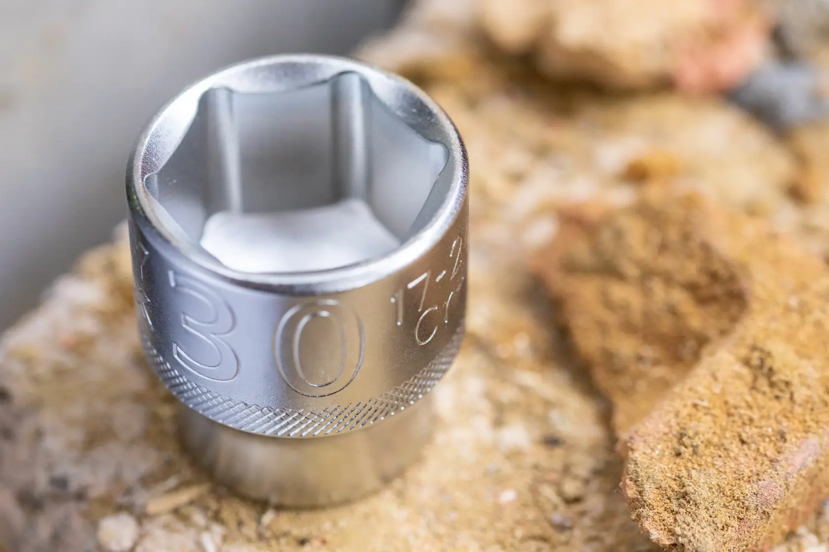 STANLEY FMMT17232-0 chrome socket photography, close-up on rough stone surface.