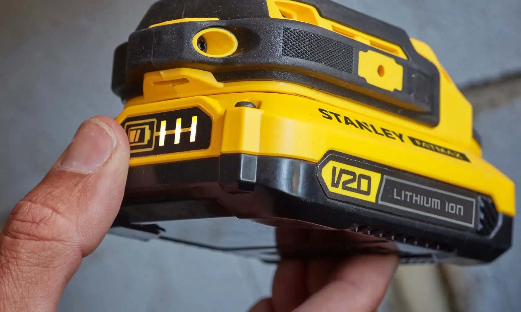 Stanley SFMCD711C2S V20 Lithium Ion battery close-up, showing indicator and yellow-black casing.
