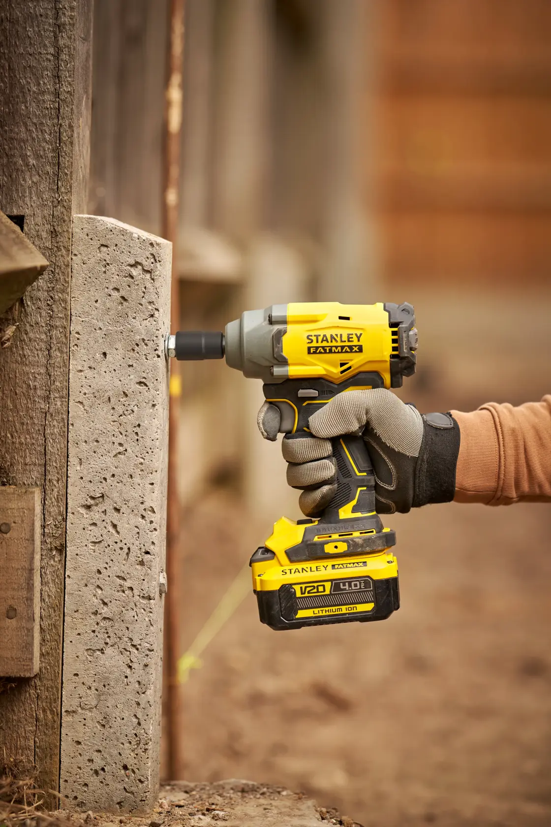 STANLEY SFMCF920B impact driver in use, yellow and black, outdoor close-up, photography category.