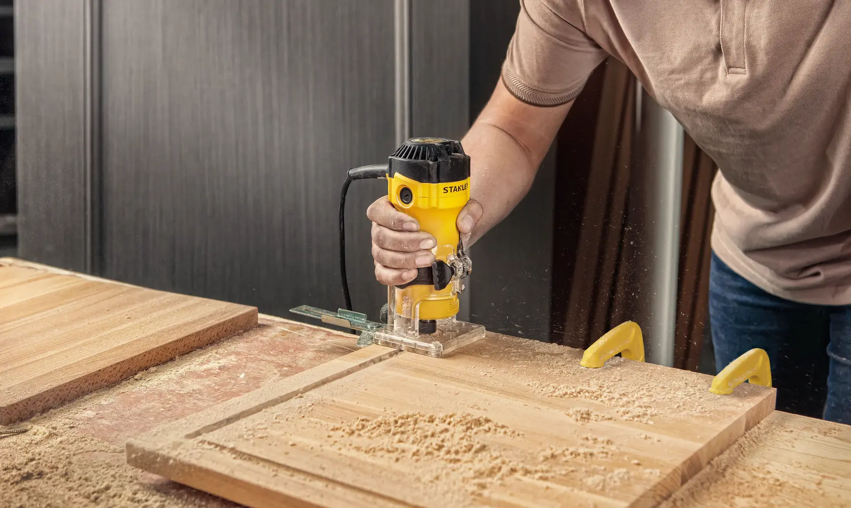Stanley photography of router in use, SKUs ST55-B2, ST55-KR, ST55, ST55-B3, ST55-B2C, ST55-BR on wood.