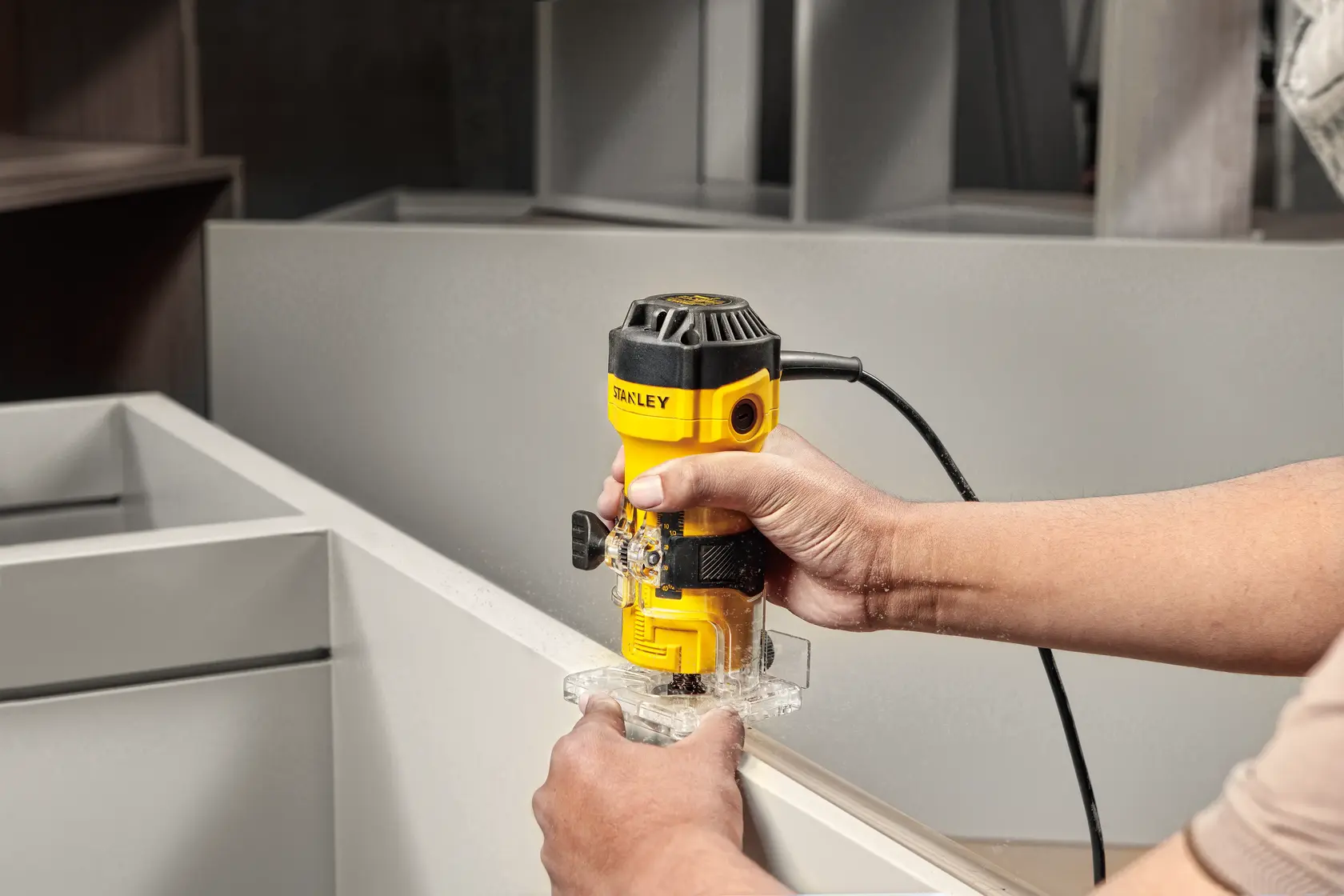 STANLEY router ST55-B2 ST55-KR ST55 ST55-B3 ST55-B2C ST55-BR in use on wood edge, photography product image.