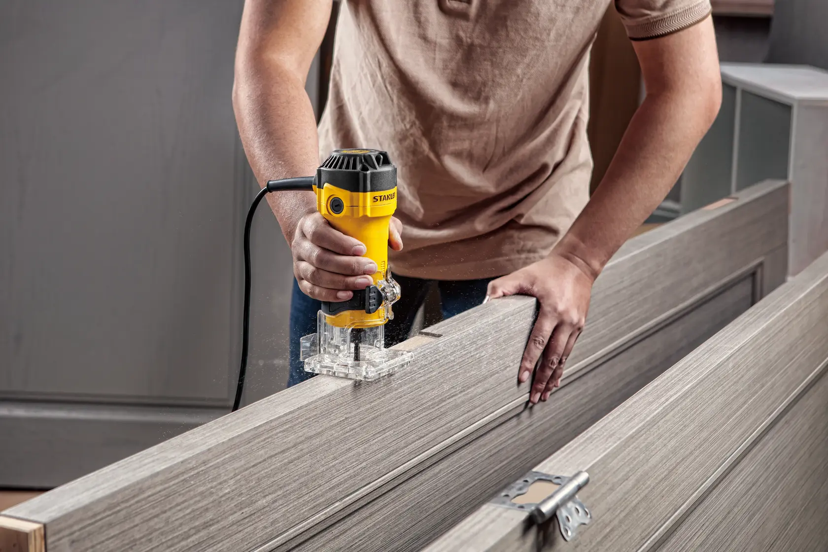 Photo of STANLEY router in use, SKUs ST55-B2, ST55-KR, ST55, ST55-B3, ST55-B2C, ST55-BR, woodworking tool.