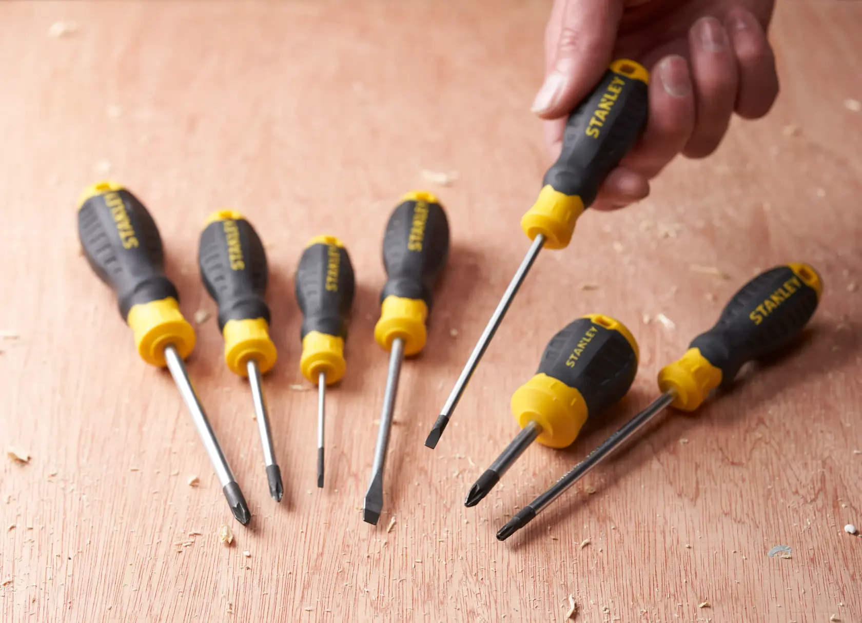 STANLEY STHT16195-0 screwdriver set, black and yellow handles, six pieces on wood surface, photography angle.