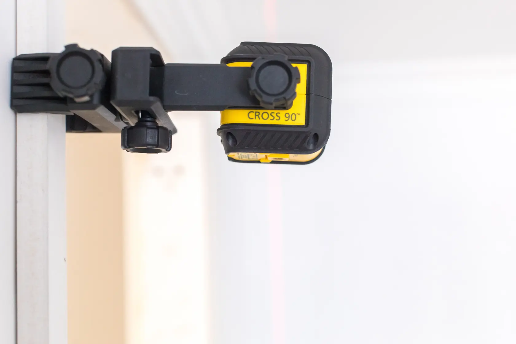 STANLEY STHT77592-1 cross line laser level, yellow and black, angled view on white background.