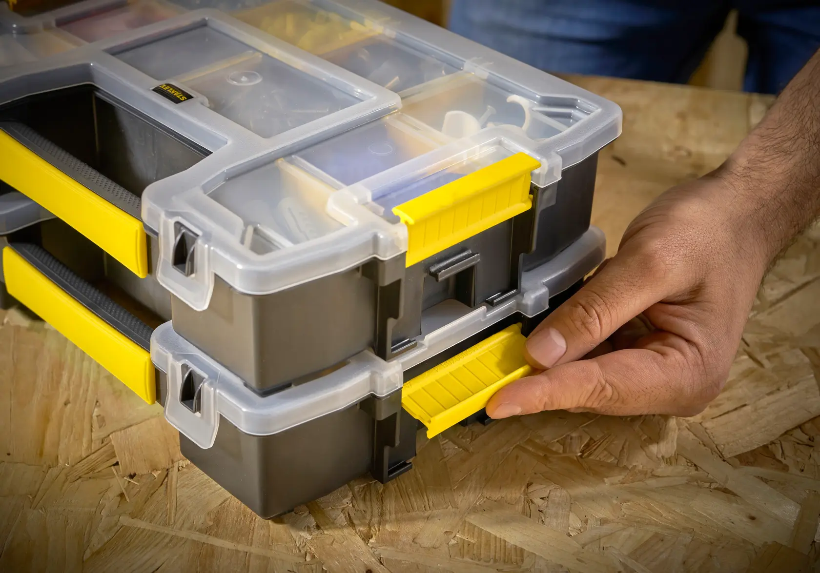 STANLEY STST1-70720 organizer with clear lid, yellow latches, and handles, photographed from the front on a table.