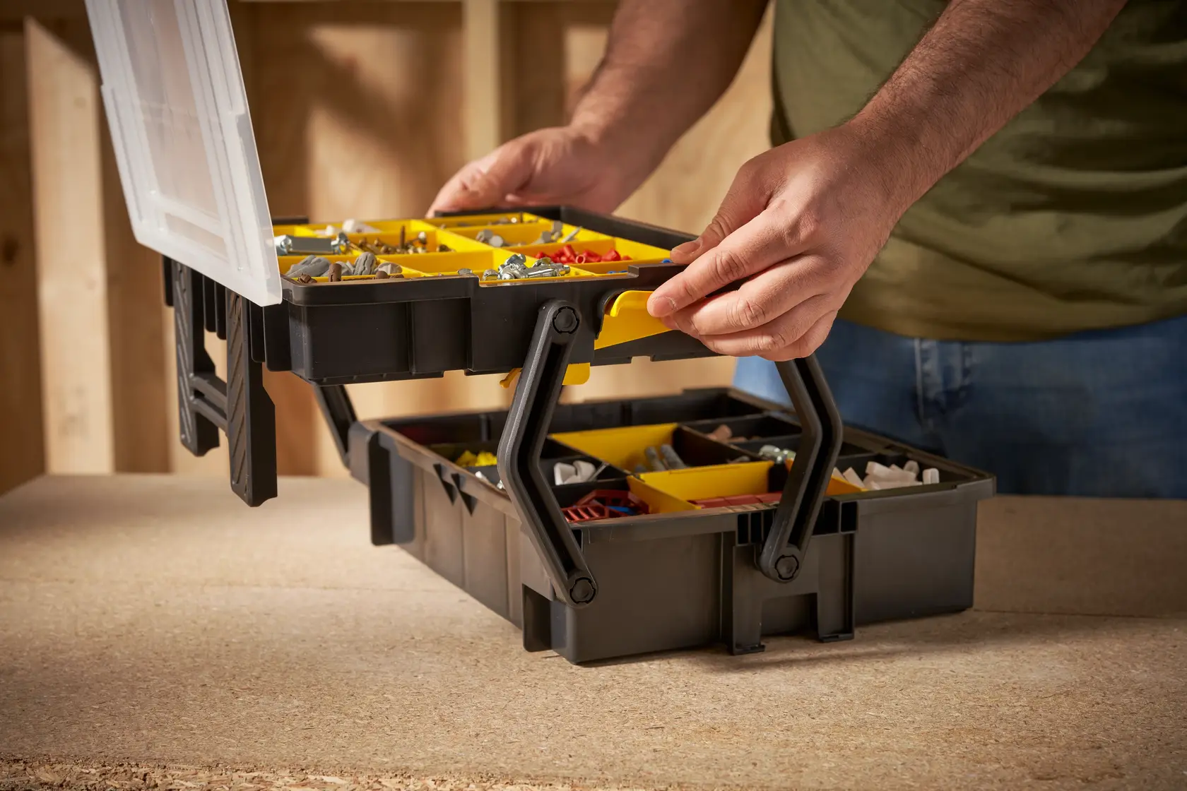 STANLEY STST1-75540 organizer box with yellow compartments for hardware shown open on workbench.
