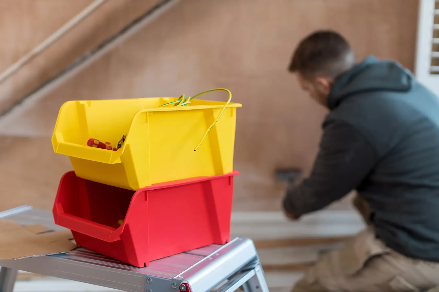 STANLEY STST82742-1 photography of yellow and red storage bins on metal step ladder indoors.